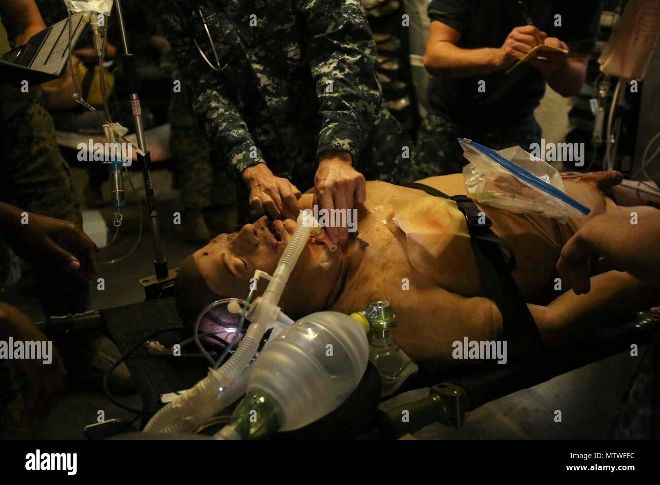 A Navy corpsman inserts a breathing tube to a notional patient as part of Naval Medical Augmentation Program training at Camp Lejeune, N.C., Jan. 26, 2017. The purpose of NMAP training is for corpsmen from different units to learn to work cohesively and be able to perform in an austere  environment. The Sailors are with 2nd Medical Battalion. (U.S. Marine Corps photo by Cpl. Ashley Lawson) Stock Photo