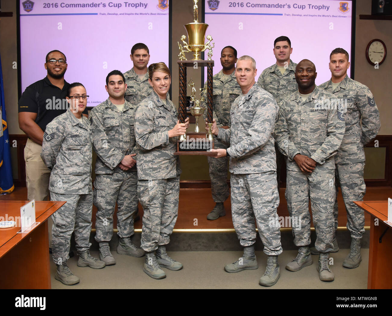Col. Michele Edmondson, 81st Training Wing commander, presents the Commander’s Trophy to Airmen from the 334th Training Squadron at Stennis Hall Jan. 18, 2017, on Keesler Air Force Base, Miss. Competing squadrons earn points based on their participation in the intramural sports program and special events facilitated by the base fitness centers. This is the 7th consecutive year the “Gators” earned the trophy. (U.S. Air Force photo by Kemberly Groue) Stock Photo