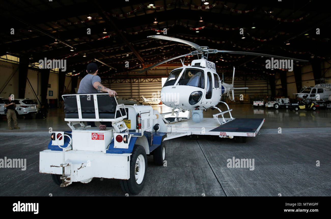 A U.S. Customs and Border Protection A-Star helicopter is pulled from a hangar prior to embarking on a flight at the U.S. Customs and Border Protection Houston Air Unit in Conroe, Texas, Jan. 30, 2017. CBP law enforcement agents and officers are in Houston to provide security for Super Bowl 51. U.S. Customs and Border Protection Photo by Glenn Fawcett Stock Photo