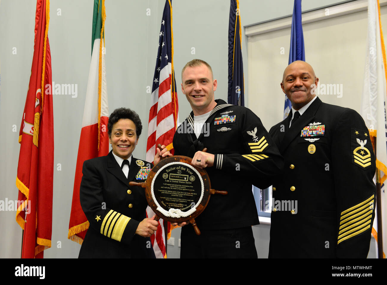 170127-N-SS492-648 NAVAL SUPPORT ACTIVITY NAPLES, Italy (Jan. 27, 2017) From left to right: Commander, U.S. Naval Forces Europe-Africa, Adm. Michelle Howard; U.S. Naval Forces Europe-Africa Sea Sailor of the Year, Intelligence Specialist 1st Class Kevin Pulley; and U.S. Naval Forces Europe-Africa Fleet Master Chief Raymond D. Kemp Sr. pose for a photo as Howard presents Pulley with a plaque at the Commander, U.S. Naval Forces Europe-Africa Sailor of the Year ceremony Jan. 27, 2017.  U.S. Naval Forces Europe-Africa, headquartered in Naples, Italy, oversees joint and naval operations, often in c Stock Photo