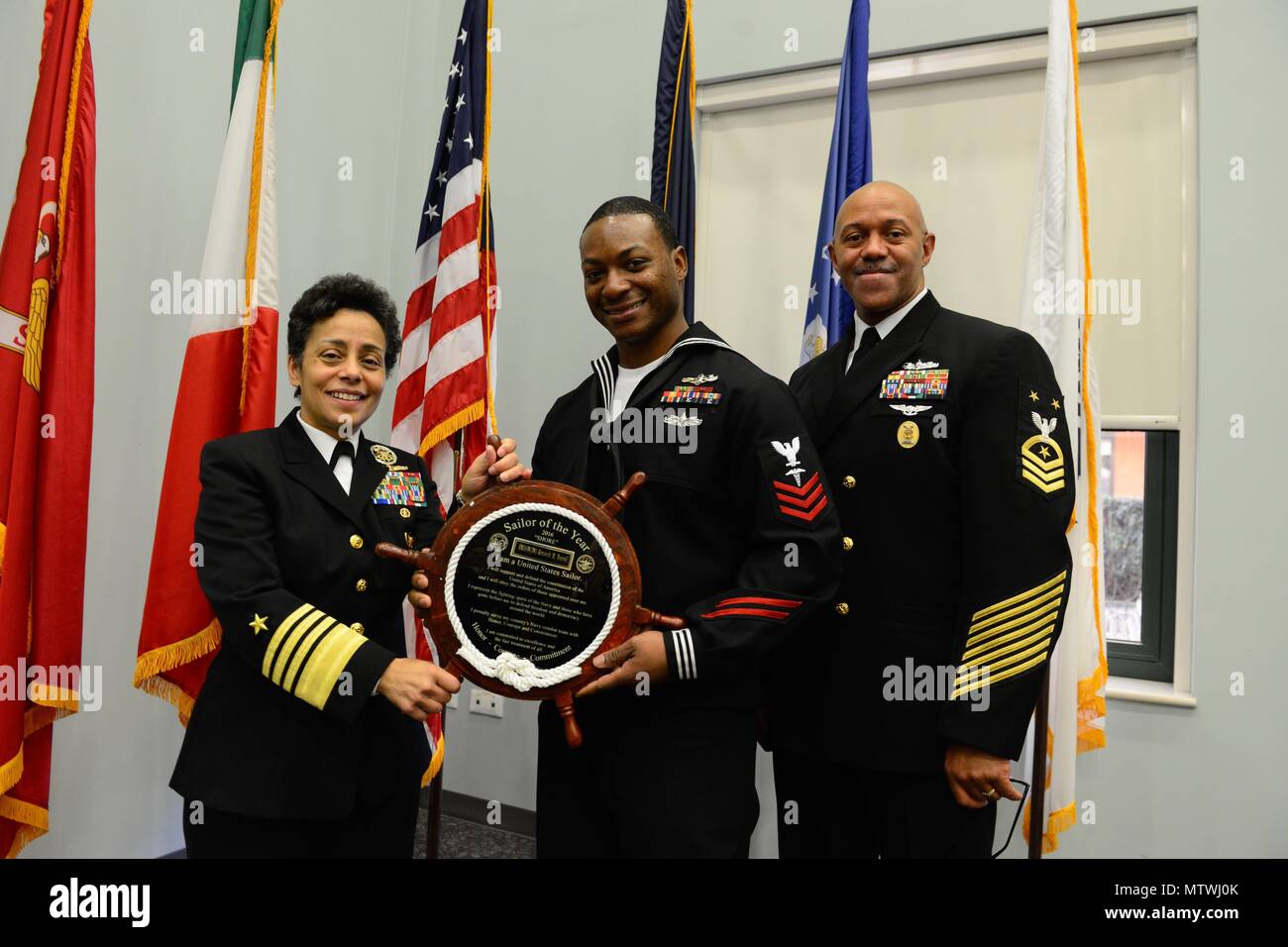 170127-N-SS492-679 NAVAL SUPPORT ACTIVITY NAPLES, Italy (Jan. 27, 2017) From left to right: Commander, U.S. Naval Forces Europe-Africa, Adm. Michelle Howard; U.S. Naval Forces Europe-Africa Shore Sailor of the Year, Hospital Corpsman 1st Class Kenneth Terrell; and U.S. Naval Forces Europe-Africa Fleet Master Chief Raymond D. Kemp Sr. pose for a photo as Howard presents Terrell with a plaque at the Commander, U.S. Naval Forces Europe-Africa Sailor of the Year ceremony Jan. 27, 2017.  U.S. Naval Forces Europe-Africa, headquartered in Naples, Italy, oversees joint and naval operations, often in c Stock Photo