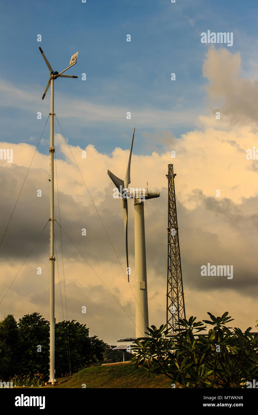 Close up of wind turbine in a wind farm against a clear blue sky ...