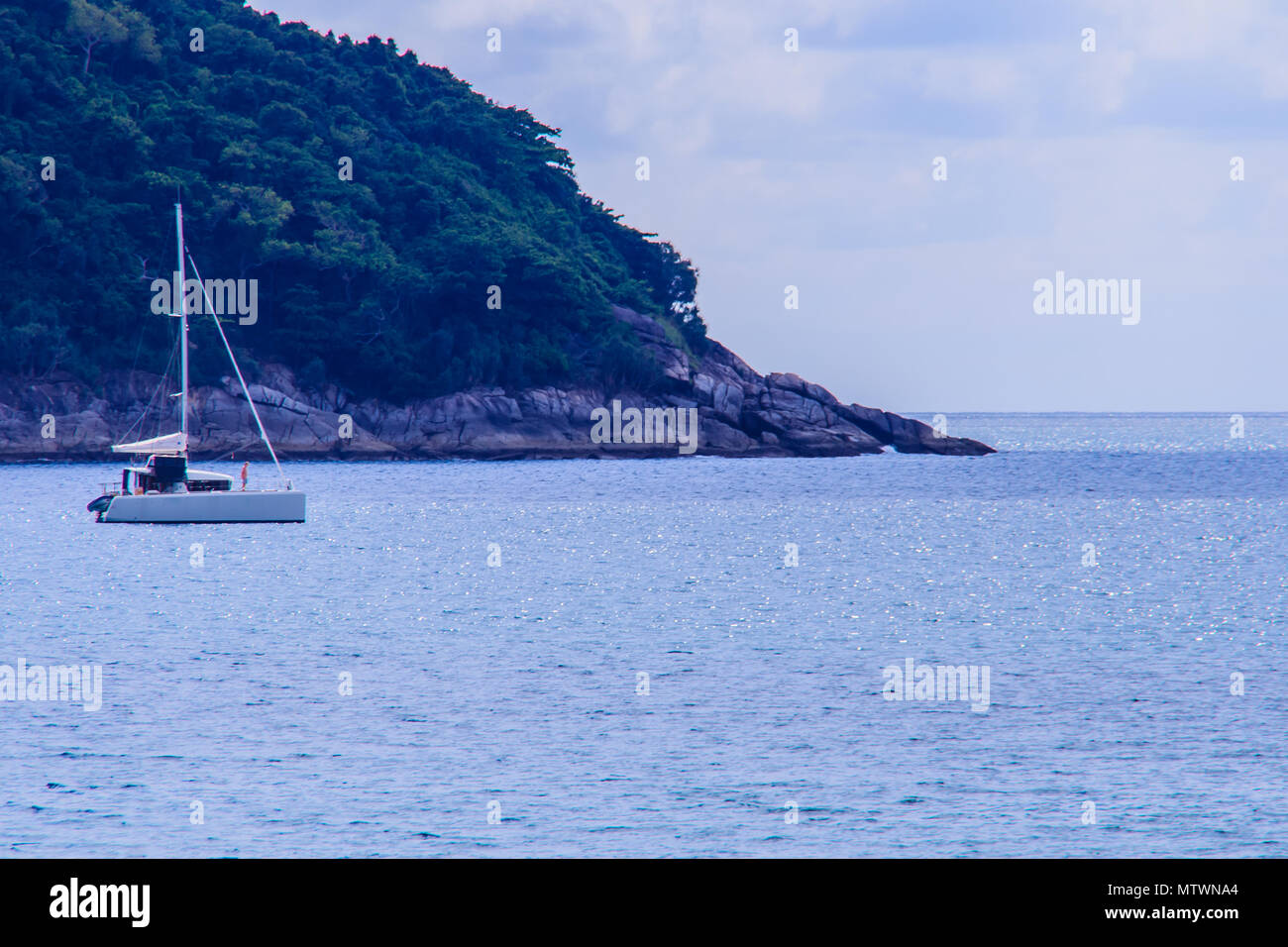 Beautiful seascape view of Nai Harn Beach Phuket with sail yachts and catamarans on background Stock Photo