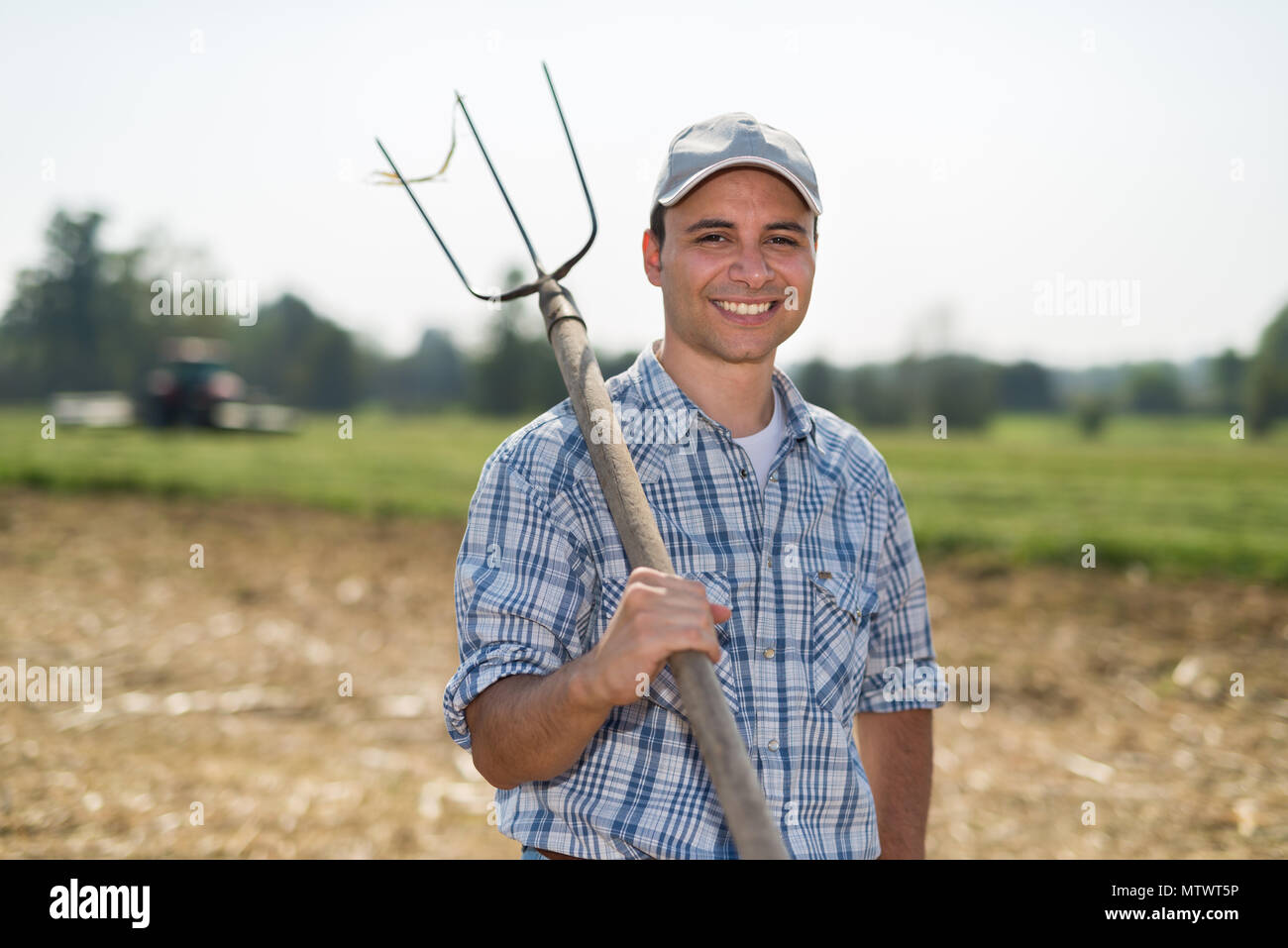 Portrait of a smiling farmer in his field Stock Photo - Alamy