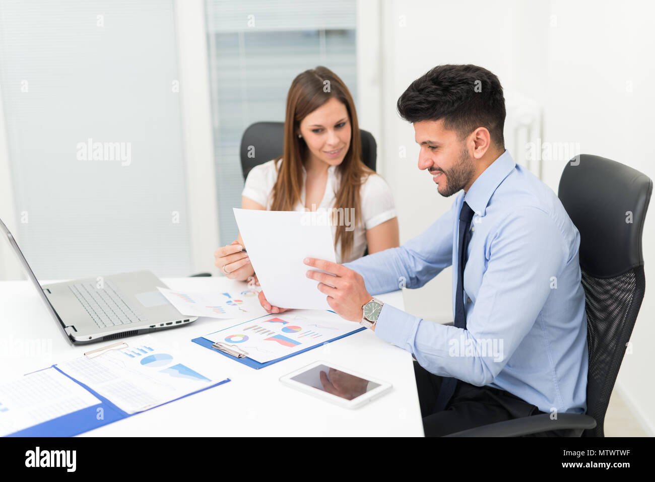 Two young business people at work in their office Stock Photo - Alamy