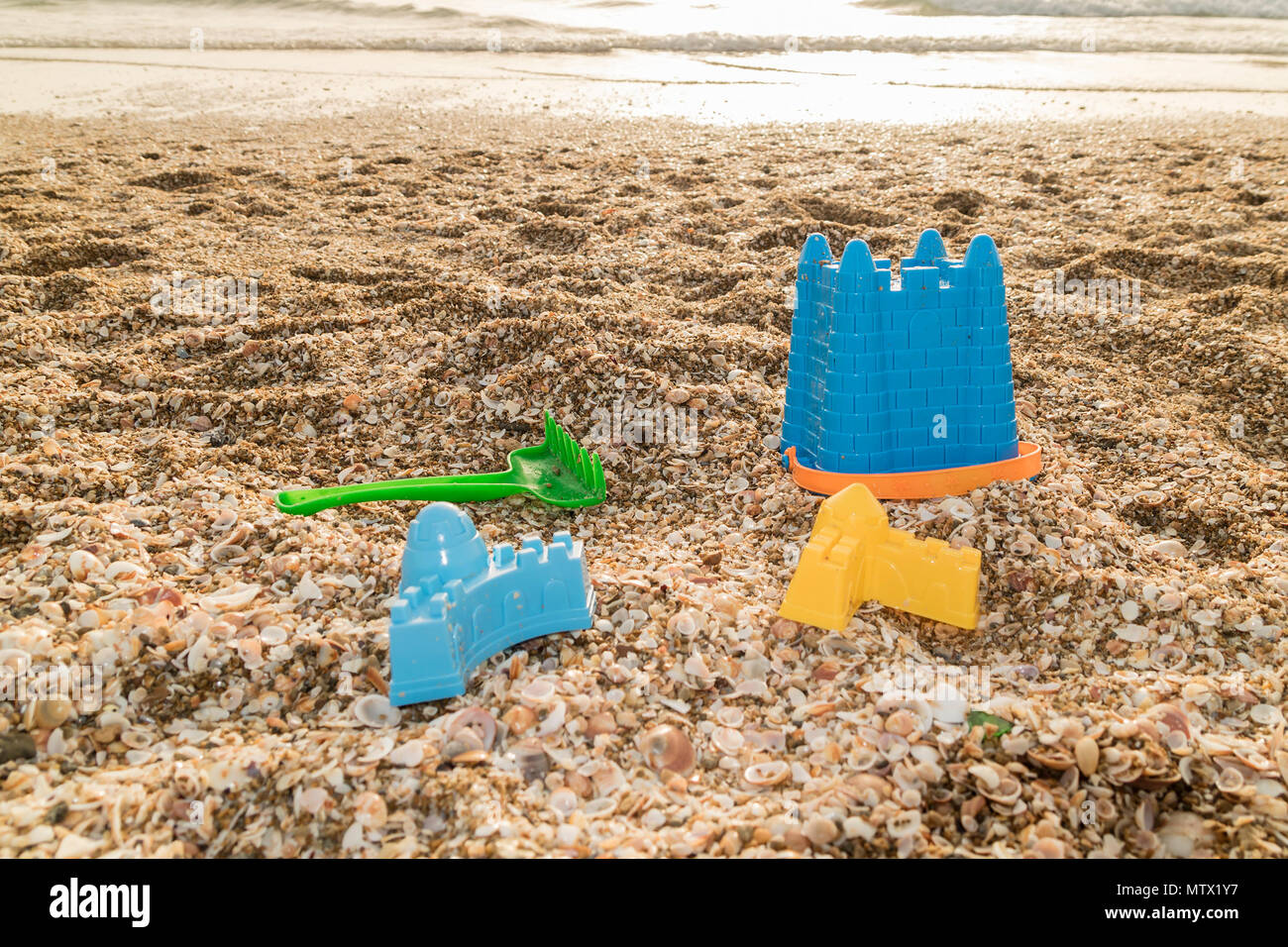 A plastic bucket and other beach toys at a beach Stock Photo Alamy
