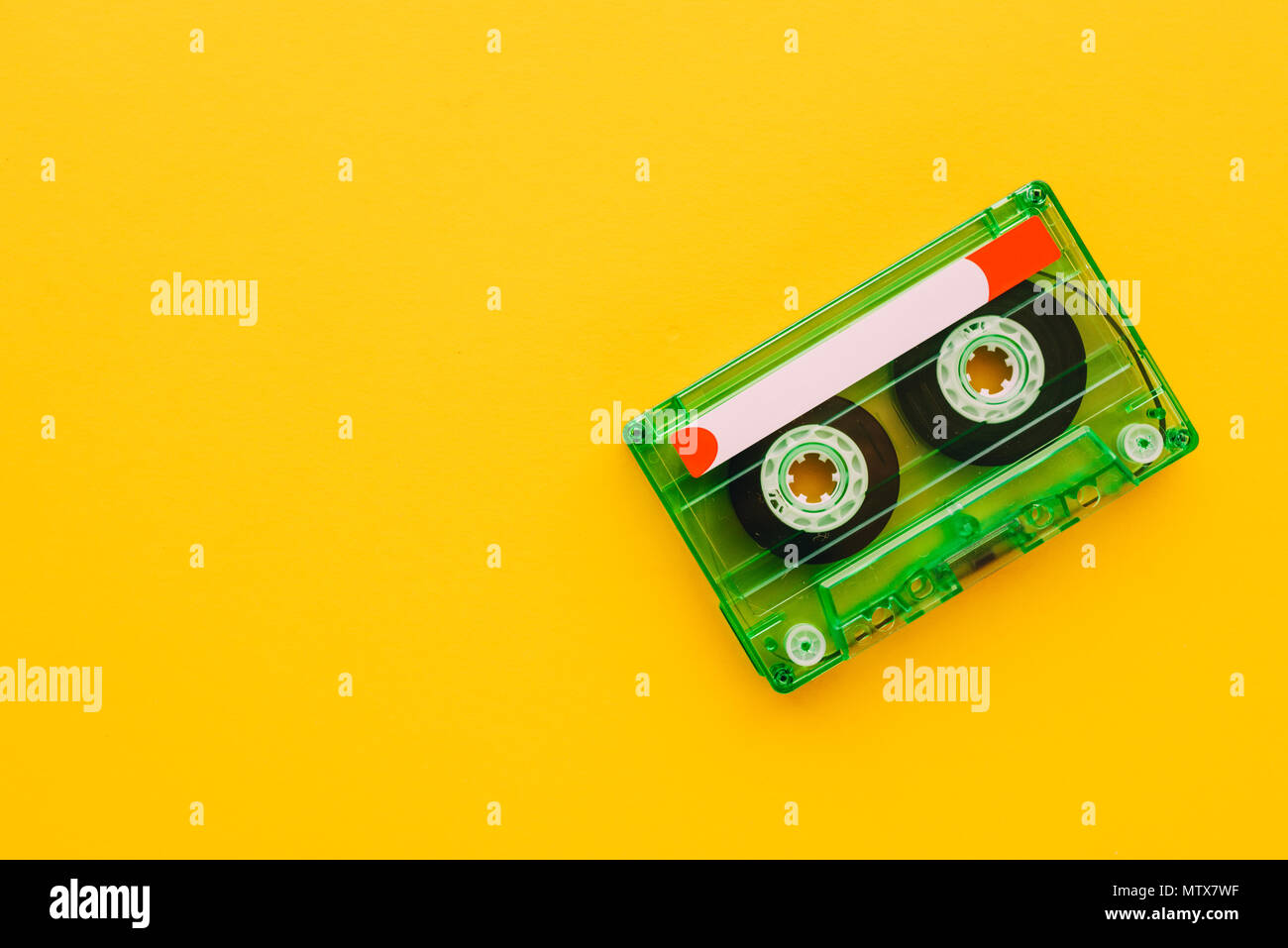 Audio cassette tape on yellow background with copy space, feeling nostalgia for retro vintage technology Stock Photo