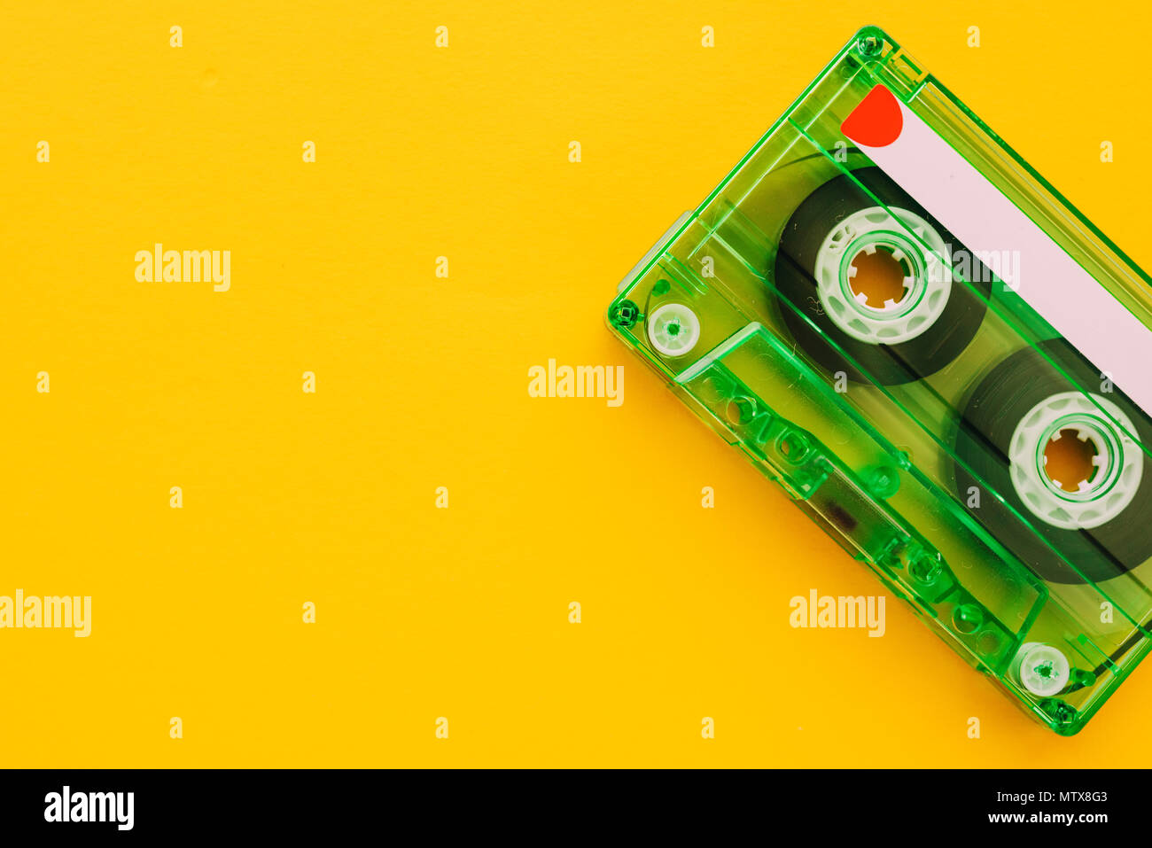 Audio cassette tape on yellow background with copy space, feeling nostalgia for retro vintage technology Stock Photo