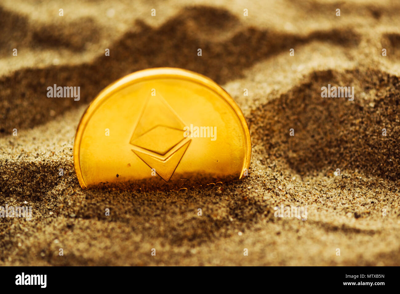 Single ethereum cryptocurrency coin buried in sand, conceptual image for  crypto mining and newly found treasures metaphor, selective focus Stock  Photo - Alamy