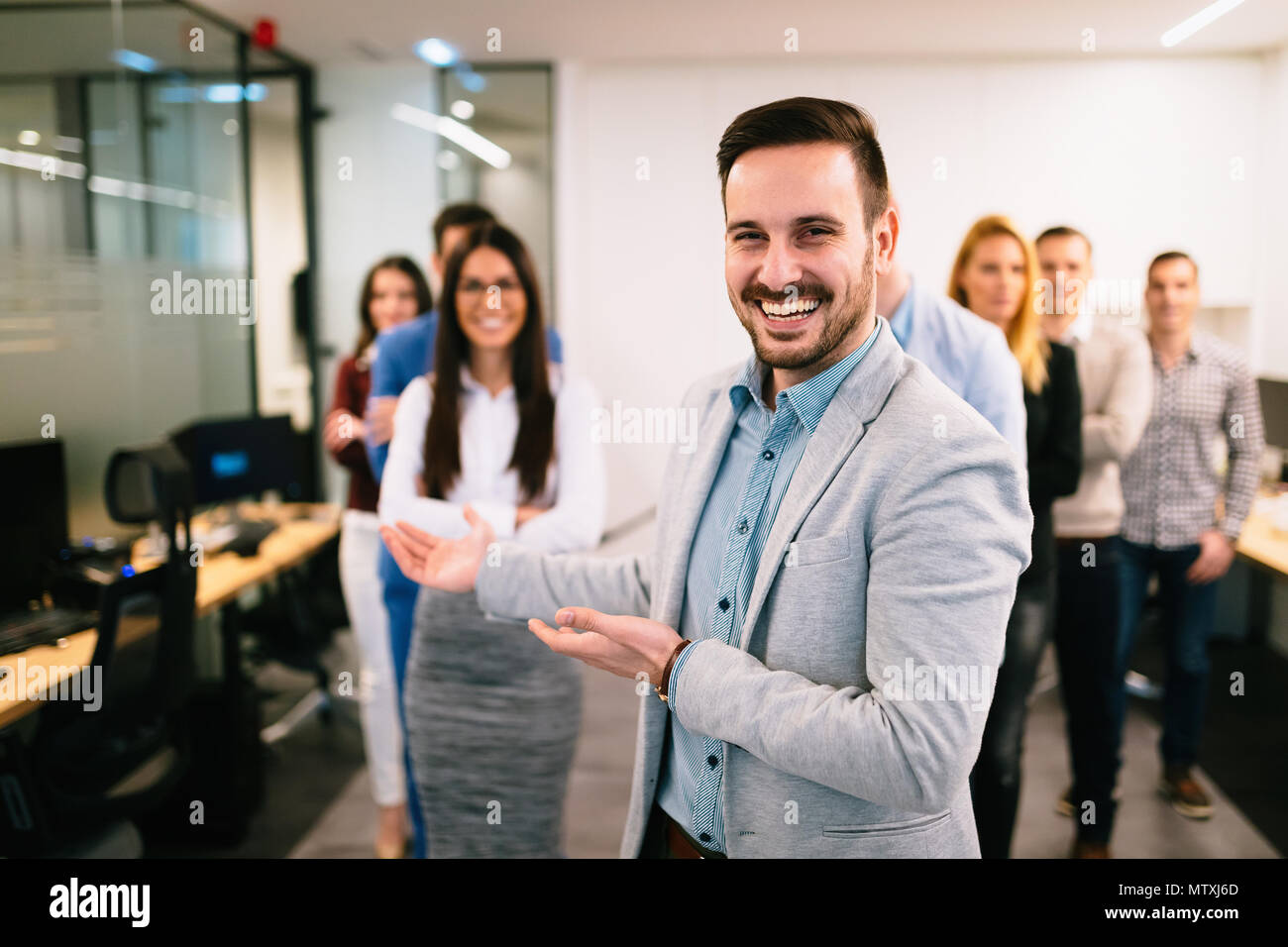 Portrait of business team posing in office Stock Photo - Alamy