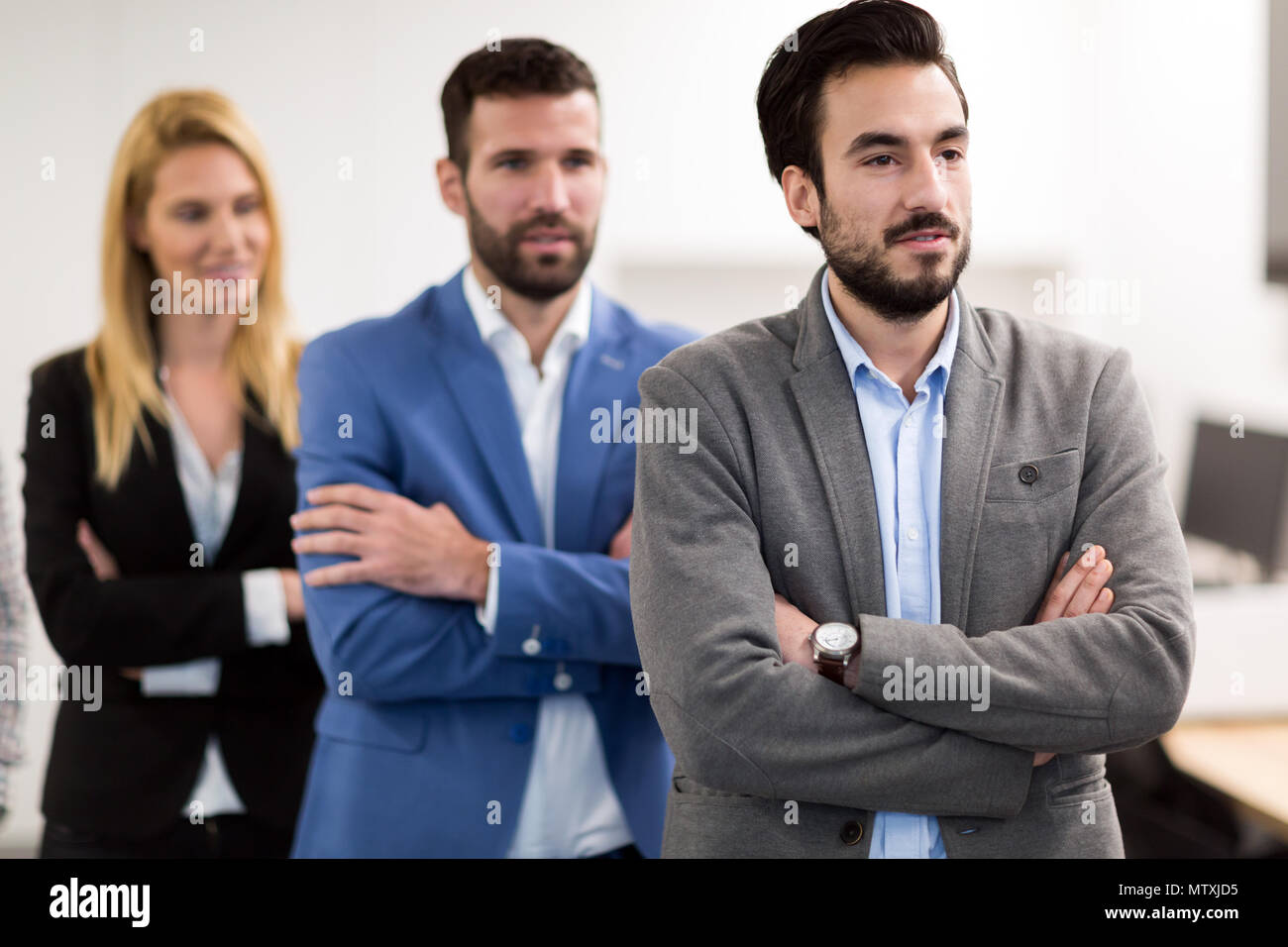 Portrait of business team posing in office Stock Photo - Alamy
