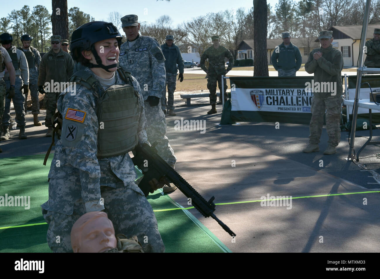 South Carolina Army National Guard Sgt. Rachel Clark, human resources non-commissioned officer with the 218th Leadership Regiment, runs through the 'Battle Challenge' during the 2017 Best Warrior Competition at McCrady Training Center in Eastover, S.C., Jan 30, 2017. The Battle Challenge is a mobile obstacle course requiring participants to perform nine tasks under pressure of time, including a cargo net climb, a knotted rope descent, wall surmount, ammunition resupply, low crawl, gas can carry, marksmanship tasks, and a service member-down rescue. The event was open to all military service me Stock Photo