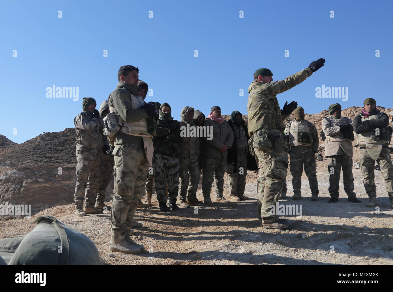 A British trainer from 4th Battalion "The Rifles" indicates a target