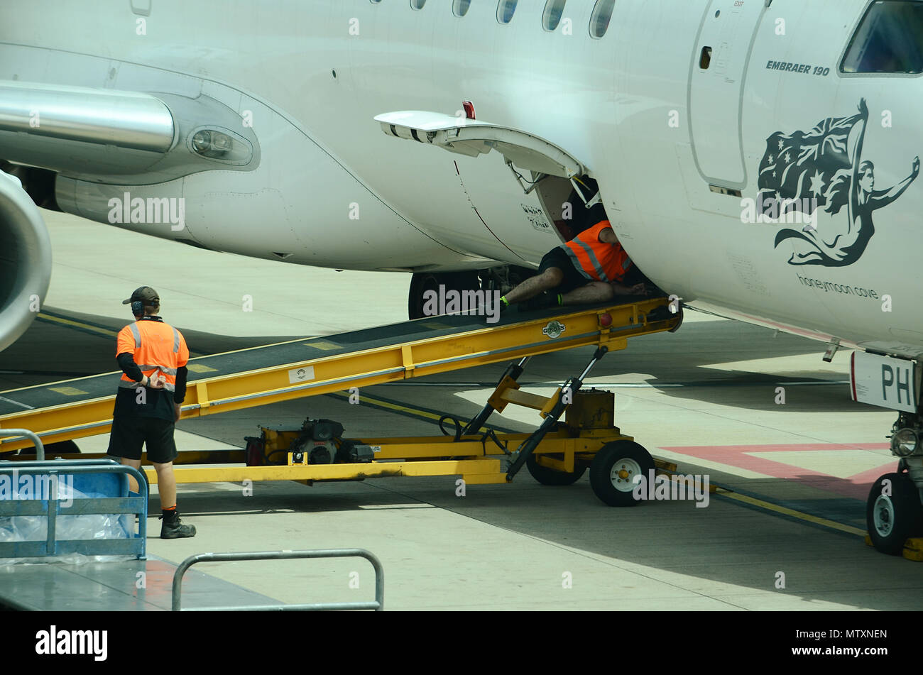 Luggage being loaded into passenger jet Stock Photo