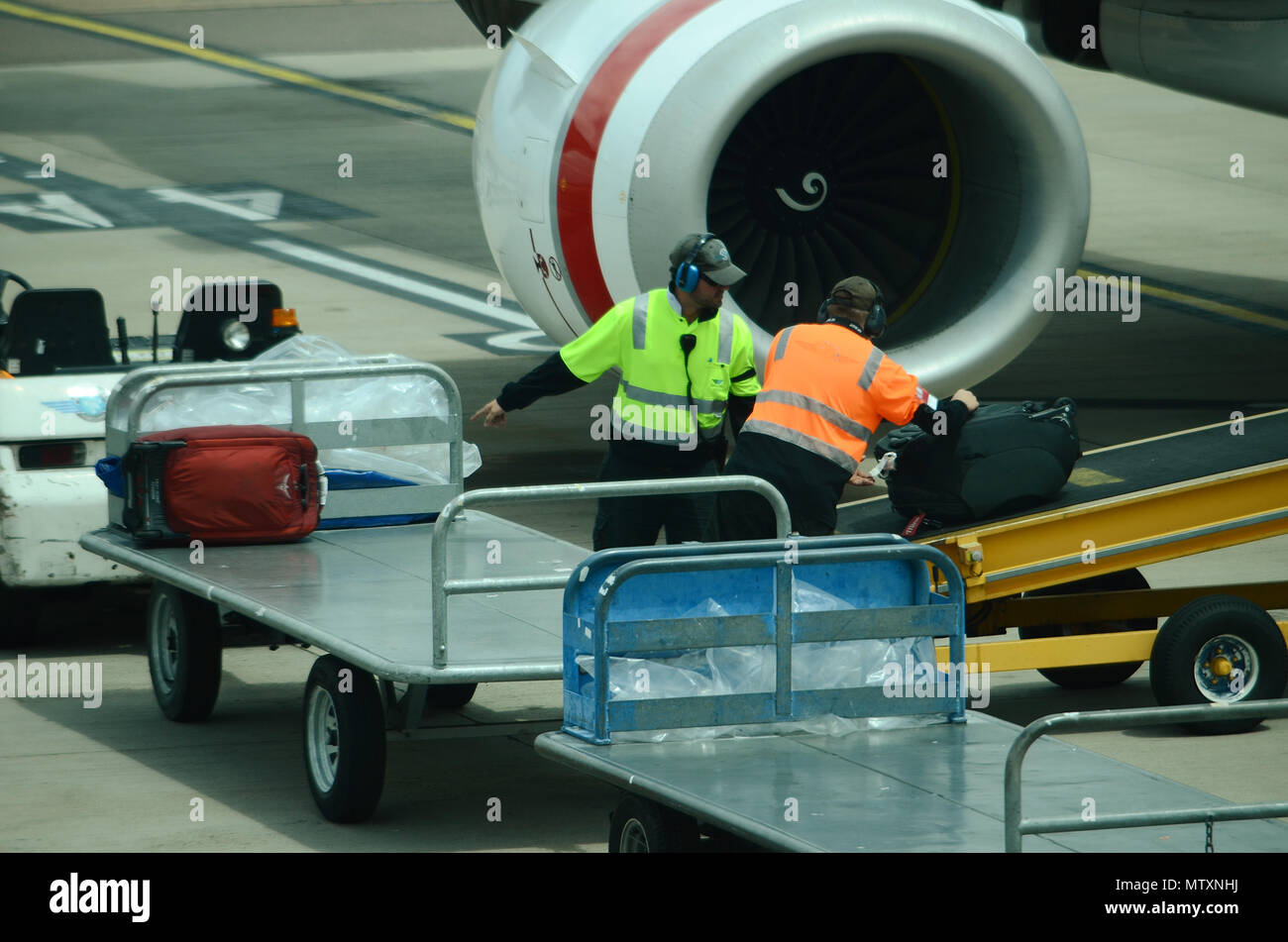 Luggage being loaded into passenger jet Stock Photo