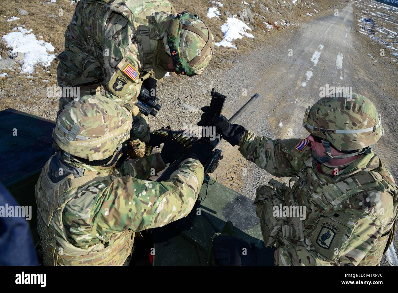 U.S. Army paratroopers from the 173rd Brigade Support Battalion, 173rd Airborne Brigade load  their .50-caliber machine gun before qualification during Exercise Lipizzaner III in Bac, Slovenia, on Jan. 25, 2017. Lipizzaner is a combined squad-level training exercise in preparation for platoon evaluation, and to validate battalion-level deployment procedures. (U.S. Army photo by Massimo Bovo) Stock Photo