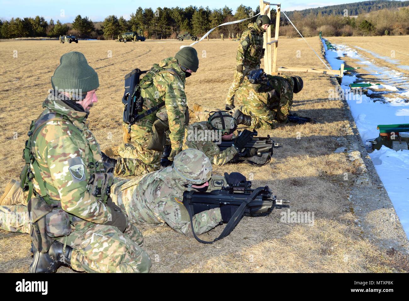 U.S. Army paratroopers from the 173rd Brigade Support Battalion, 173rd Airborne Brigade and Slovenian soldiers cross-train on the M4 carbine rifles and FN2000 assault rifles during exercise Lipizzaner III in Bac, Slovenia, on Jan. 26, 2017. Lipizzaner is a combined squad-level training exercise in preparation for platoon evaluation, and to validate battalion-level deployment procedures. (Photo by Visual Information Specialist Massimo Bovo/released) Stock Photo