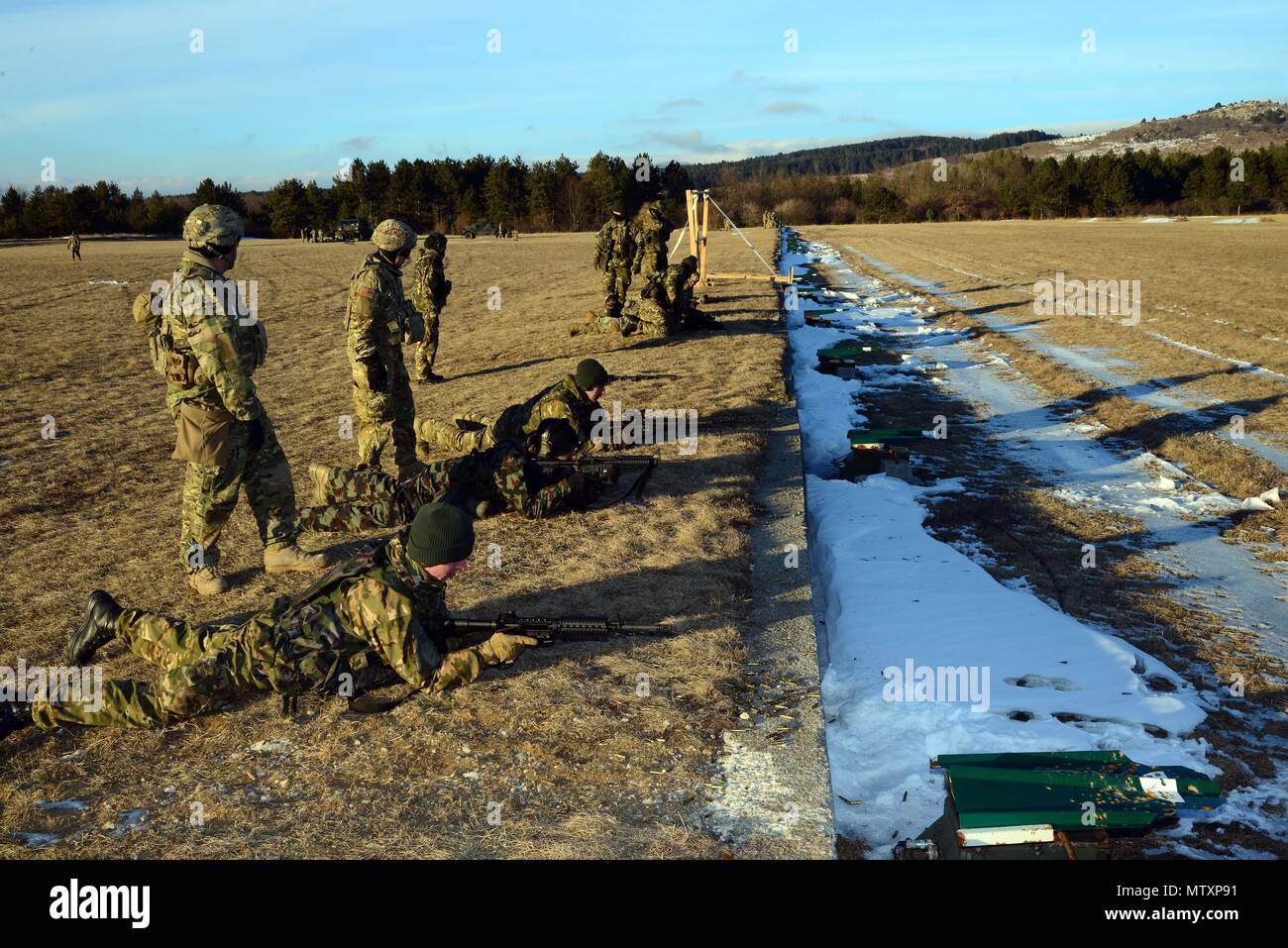U.S. Army paratroopers from the 173rd Brigade Support Battalion, 173rd Airborne Brigade and Slovenian soldiers cross-train on the M4 carbine rifles and FN F2000 assault rifles during exercise Lipizzaner III in Bac, Slovenia, on Jan. 26, 2017. Lipizzaner is a combined squad-level training exercise in preparation for platoon evaluation, and to validate battalion-level deployment procedures. (Photo by Visual Information Specialist Massimo Bovo/released) Stock Photo