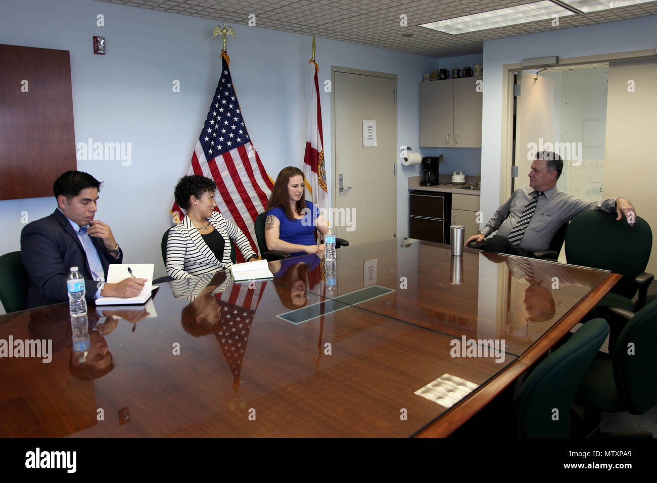 A psychological operations team discusses youth outreach with Maj. Chad  Scibilia, the Law Enforcement Bureau Director for the Monroe County  Sheriff's Office, who is role-playing a Conch Republic National Police  Commander, Jan., image size:1300x956