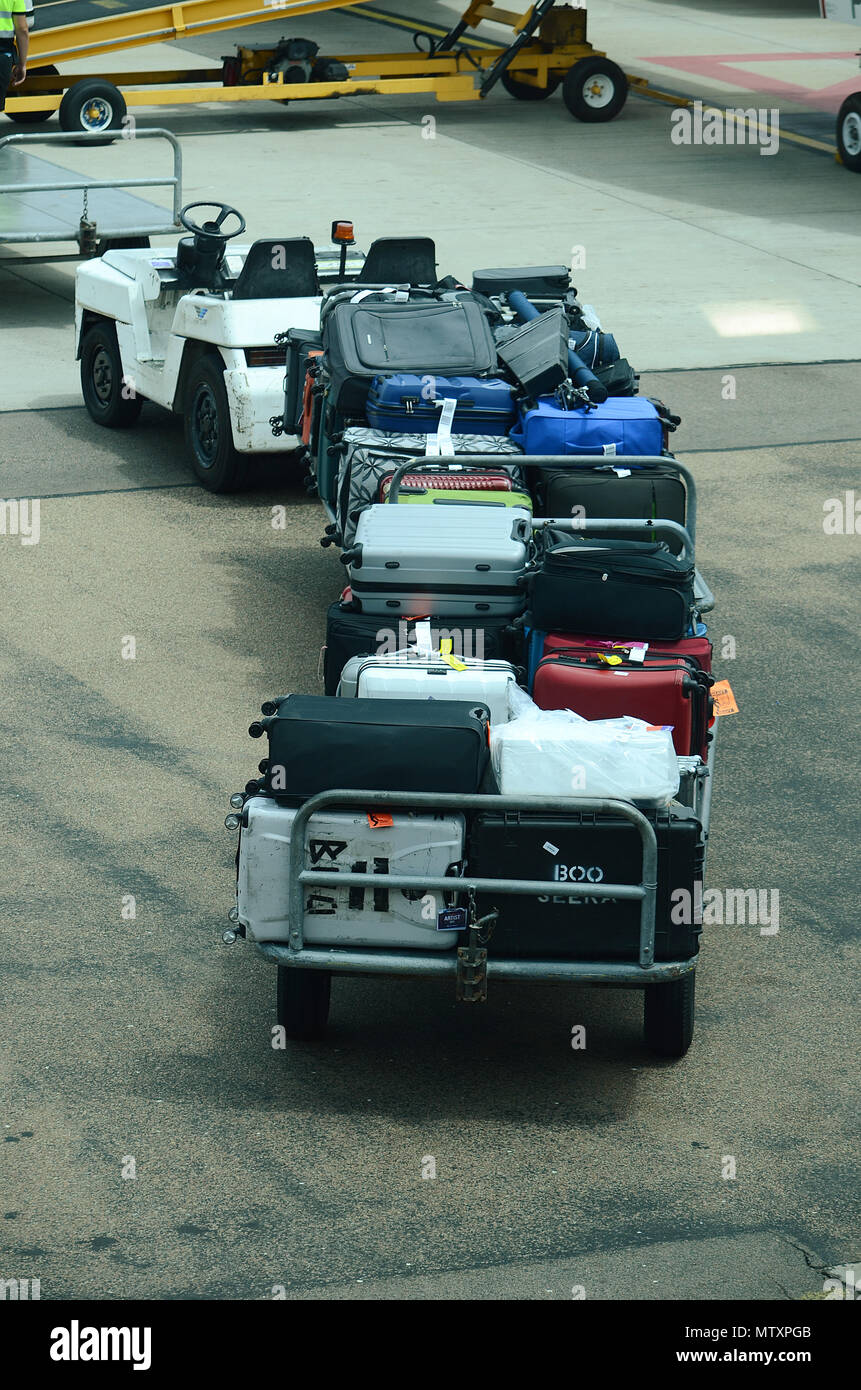 Luggage being loaded into passenger jet Stock Photo