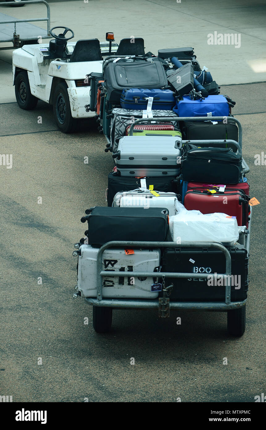 Luggage being loaded into passenger jet Stock Photo