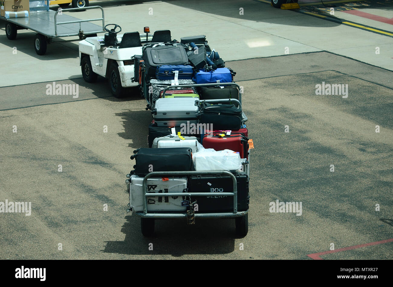 Luggage being loaded into passenger jet Stock Photo