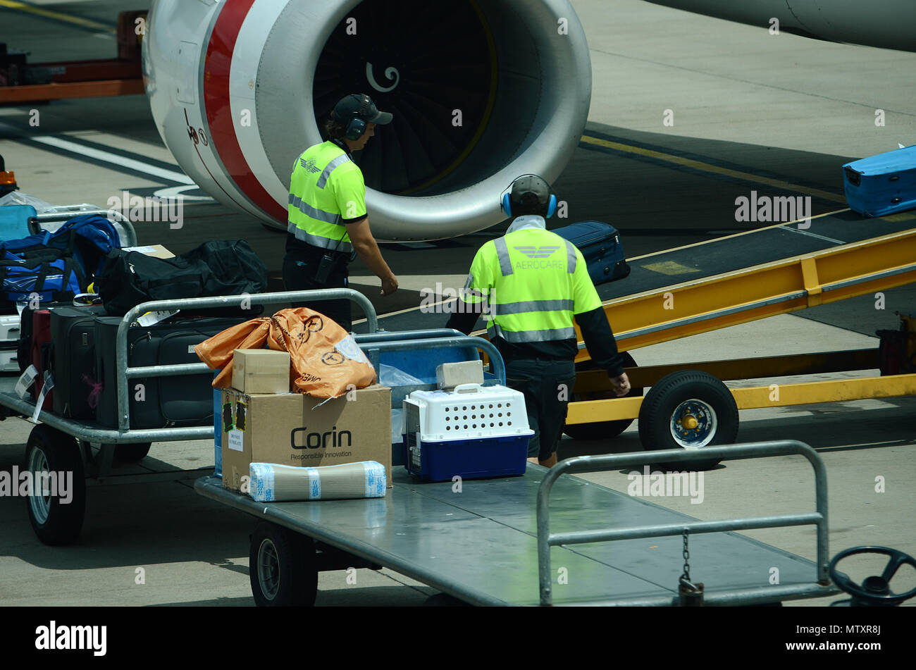 Luggage being loaded into passenger jet Stock Photo