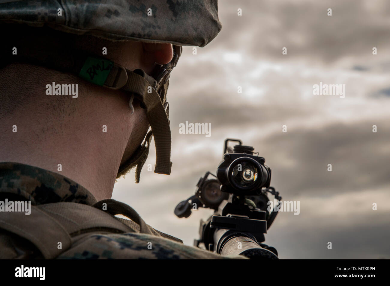 A U.S. Marine with Alpha Company, Infantry Training Battalion (ITB), School of Infantry-East, looks down range after firing a M-203 grenade launcher during a live fire range at Camp Lejeune, N.C., Jan. 12, 2017. Marines with Alpha Company conducted a live fire range as part of their qualification with the M-203 grenade launcher. (U.S. Marine Corps photo by Cpl. Manuel A. Serrano) Stock Photo