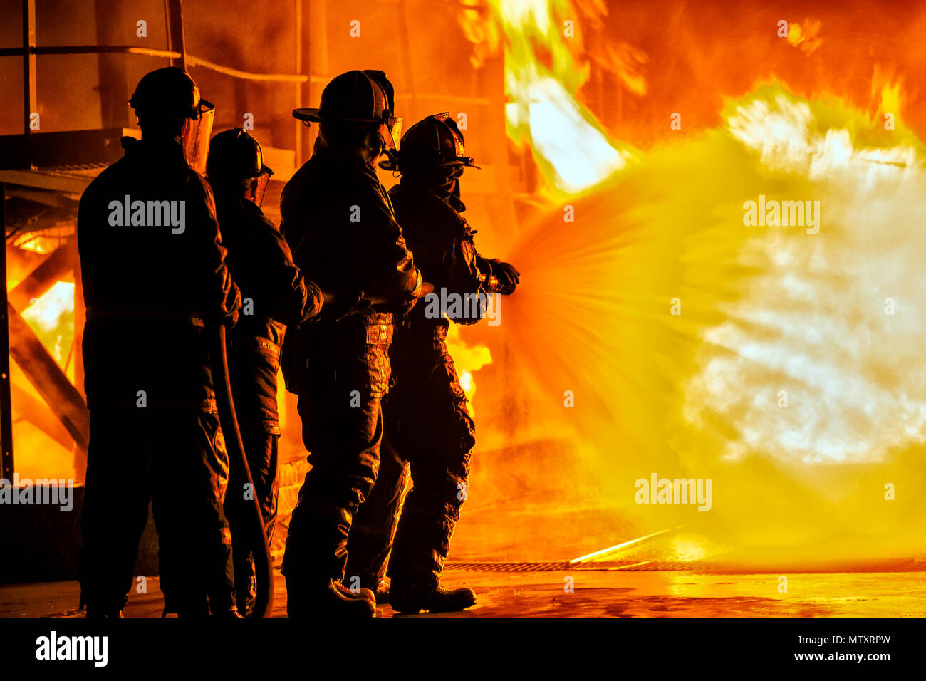 JOHANNESBURG, SOUTH AFRICA - MAY, 2018 Firefighters spraying down fire during firefighting training exercise Stock Photo