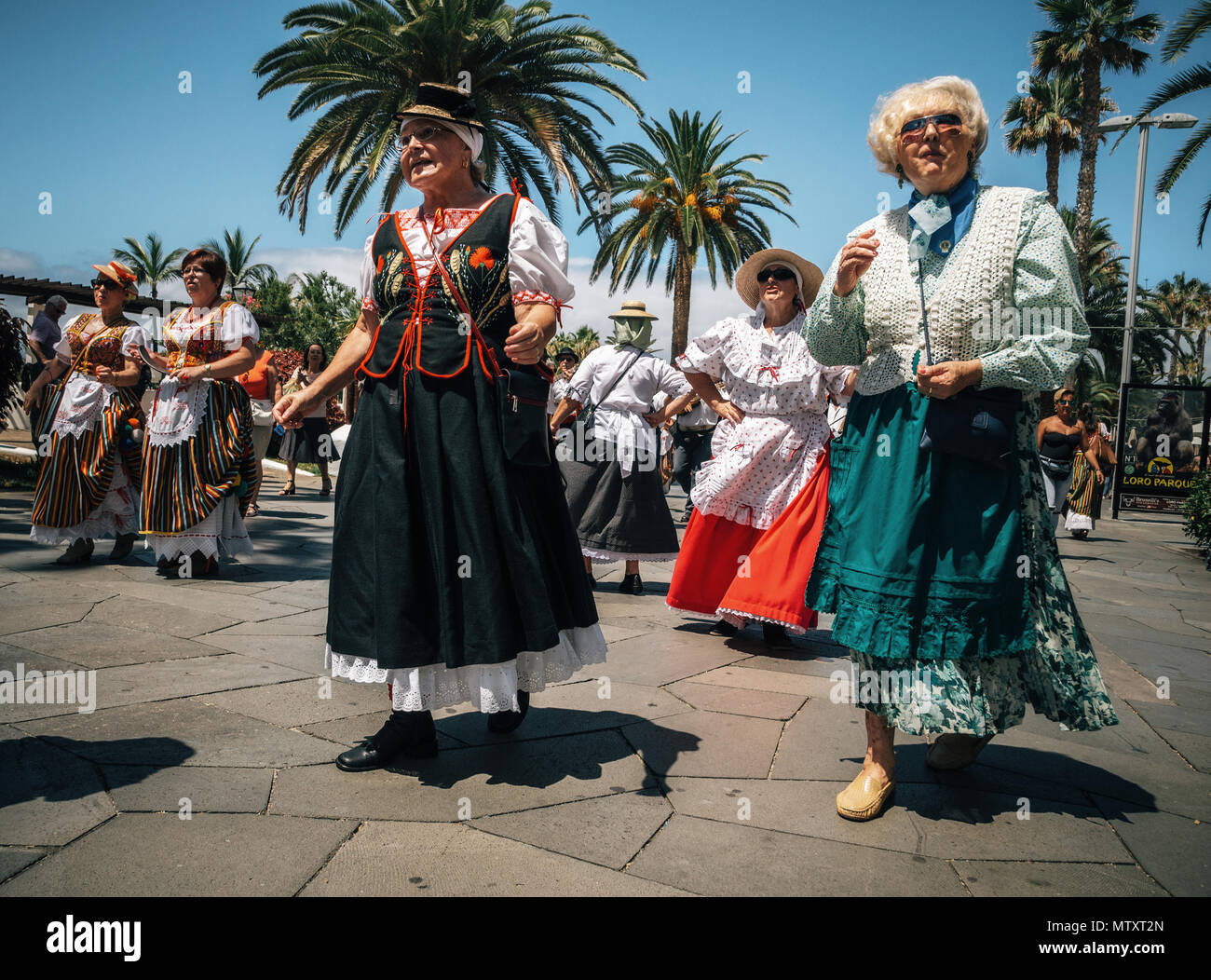 Puerto de la Cruz, Tenerife, Canary Islands - May 30, 2017: Canaries people dressed in traditional clothes walk along the street, sign and dance. Loca Stock Photo