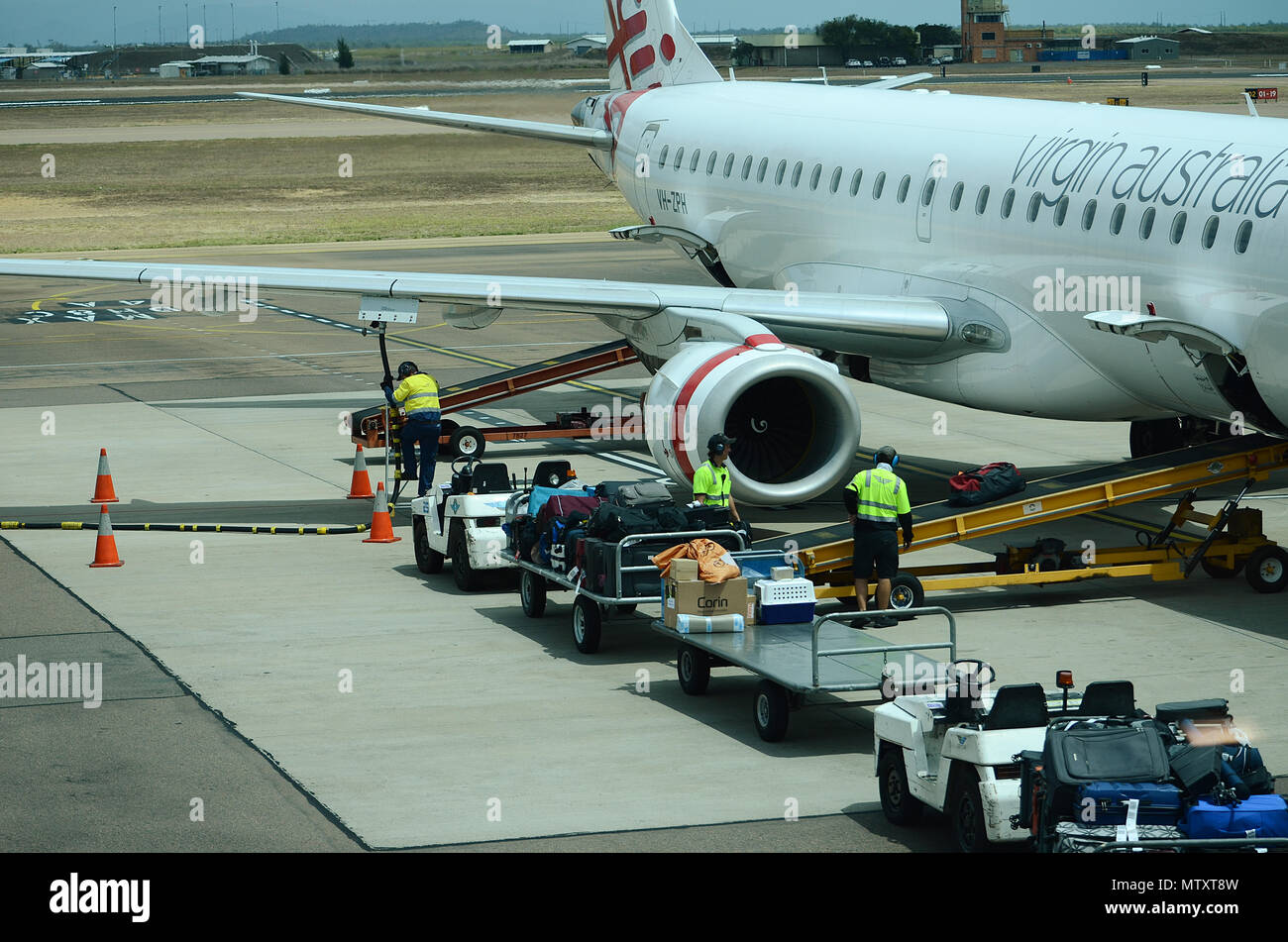 Luggage being loaded into passenger jet Stock Photo