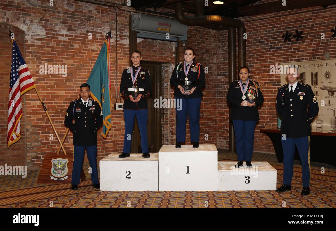 Sporter class top three individual finishers, Erin Young from Pueblo, Colorado, 1st place; Levi Carlson from Fort Mill, South Carolina, 2nd place; and Aireonna Gonzales from Fountain, Colorado, 3rd place; receive their awards during the banquet held Jan. 29 after the conclusion of the 2017 U.S. Army Junior Air Rifle National Championship. The Sporter rifle competition included three-position firing in prone, standing and kneeling. Juniors shot 20 rounds in a time limit of 20 minutes for prone and kneeling and 20 rounds in 25 minutes for standing.  (U.S. Army photo by Michelle Lunato/Released) Stock Photo