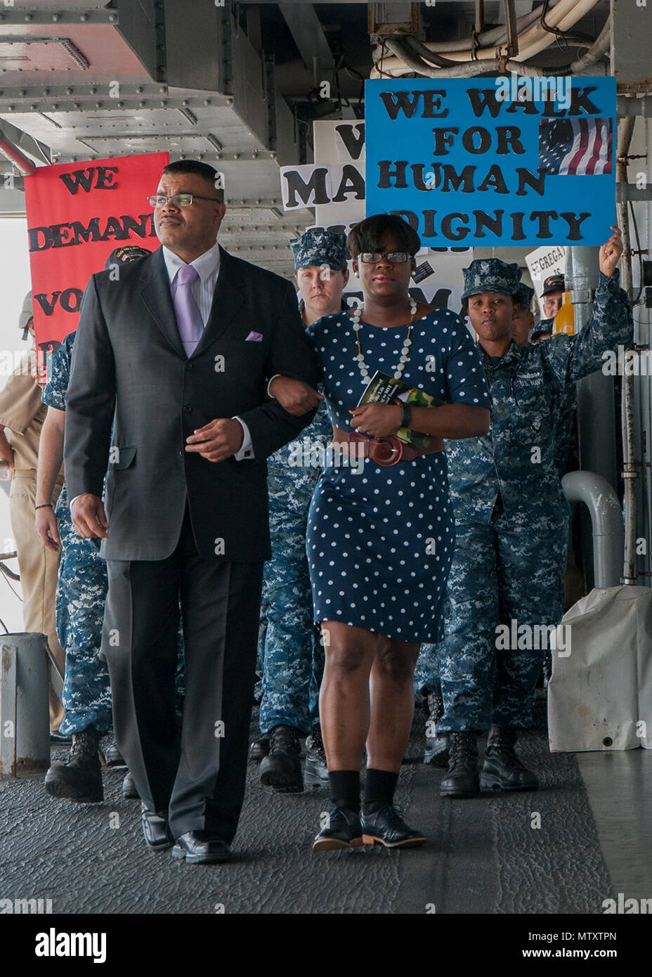 170131-N-DS883-009    SANTA RITA, Guam (Jan. 31, 2017) Senior Chief Operations Specialist Charles Green and Machinist Mate 1st Class Ashley Johnson, assigned to the submarine tender USS Frank Cable (AS 40), lead Sailors during a march honoring Dr. Martin Luther King Jr. aboard the ship, Jan. 31. The ship’s diversity committee held the event to reenact the1965 Selma-to-Montgomery March for voting rights led by Martin Luther King Jr.’s Southern Christian Leadership Conference. (U.S. Navy photo by Mass Communication Specialist Seaman Heather C. Wamsley/Released) Stock Photo