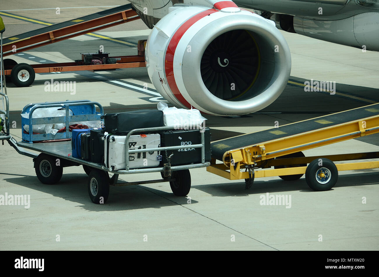 Luggage being loaded into passenger jet Stock Photo