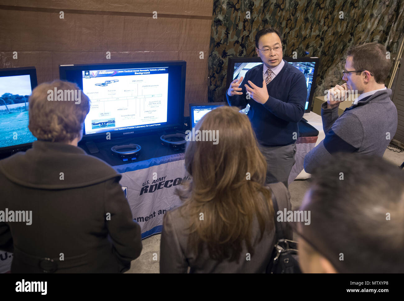U.S. Army Research Laboratory engineer Tim Vong (center), explains the