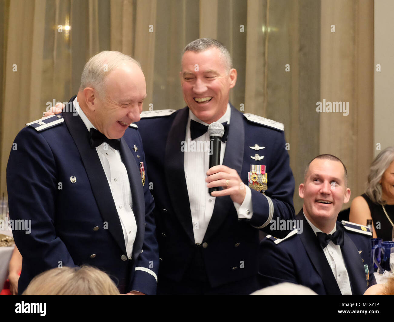 Retired Col. Jack Anthony, 1st Space Operations Squadron commander from July 1996 – July 1998, laughs with Maj. Gen. Burke E. Wilson, Deputy Principal Cyber Advisor to the Secretary of Defense and Senior Military Advisor for Cyber, Office of the Under Secretary of Defense for Policy, Office of the Secretary of Defense, the Pentagon, Washington, D.C. during the squadron’s 25th anniversary celebration at The Mining Exchange, in Colorado Springs, Colorado, Friday, Jan. 27, 2017. Wilson was the 1 SOPS commander from July 2002 – July 2003. The former commanders recalled their prior service together Stock Photo