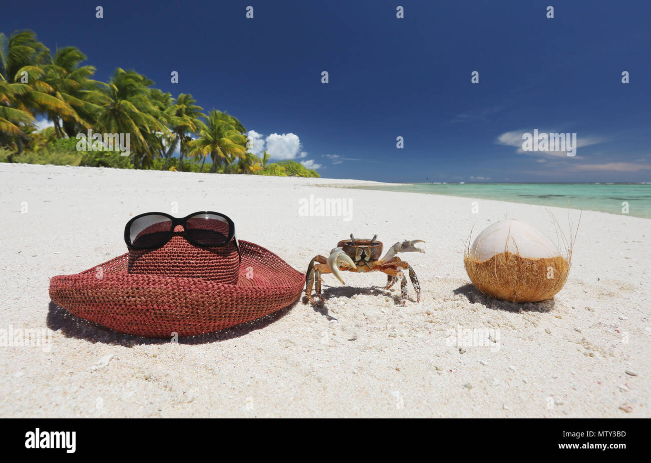 Hat, crab and coconut on tropical sandy beach, Christmas Island, Kiribati Stock Photo