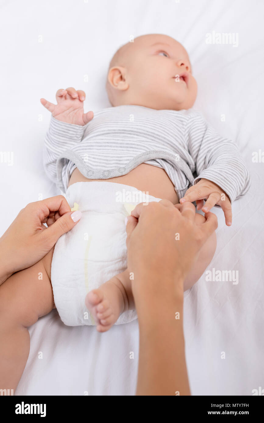 cropped shot of mother changing babys diaper Stock Photo Alamy