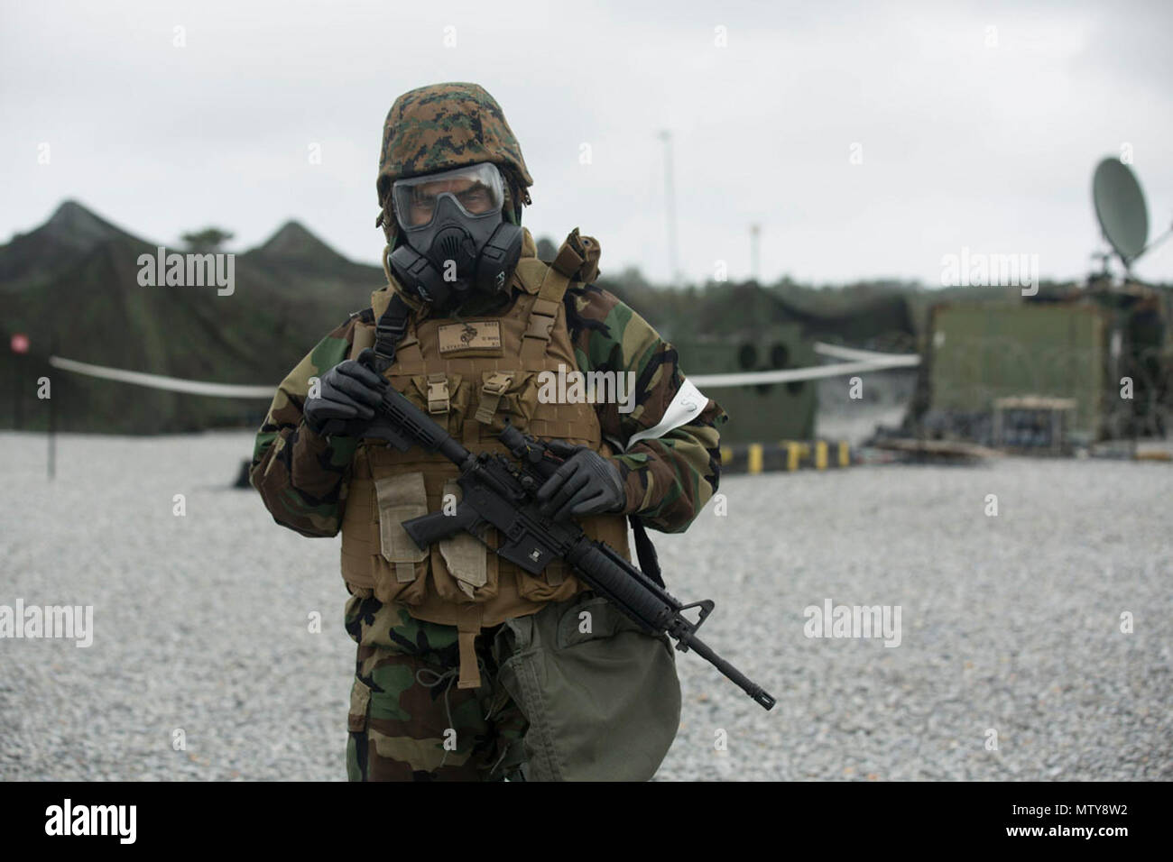 U.S. Marine Corps Lt. Colonel Giuseppe Stavale is the executive officer of the III Marine Headquarters Group (III MHG), engaging in Mission Oriented Protective Posture gear Level 4 during Marine Expeditionary Force Exercise 2017(MEFEX 17) at Range GP 304 on Marine Corps Base Camp Hansen, Okinawa, Japan, April 26, 2017. MEFEX 17, a command and control exercise conducted in a simulated deployed environment, is designed to synchronize and bring to bear the full spectrum of III MEF, while remaining ready to provide the Marine Corps with an experienced staff capable of integrating with internationa Stock Photo