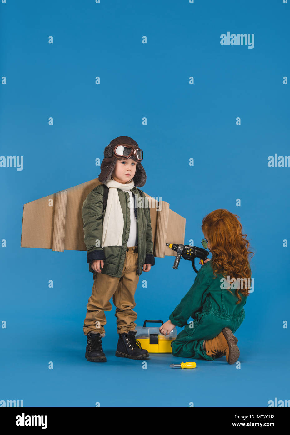 kids in pilot costumes with toy screwdriver playing together isolated ...