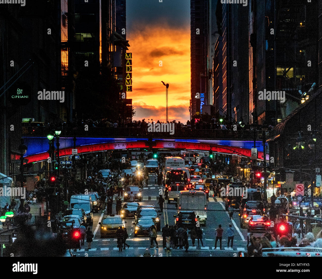 A partially cloud obscured Manhattanhenge sun set. Manhattanhenge is