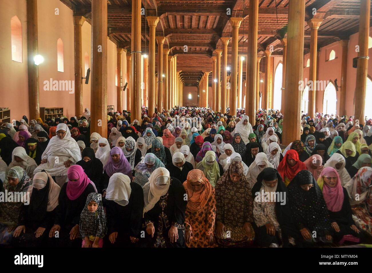 Kashmiri Muslim women offer prayers inside the historic Grand Mosque or