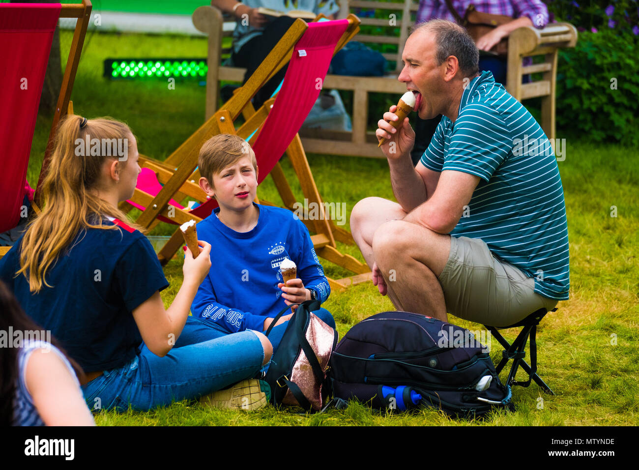 The Hay Literature Festival, Hay on Wye, Wales UK Thursday, 31 May 2018.   People enjoying a warm and muggy afternoon relaxing on the lawn  on the 8th day of the 31st annual Hay Festival of Literature and the Arts.  Described by former US President Bill Clinton as “the Woodstock of the mind”, the festival attracts the finest writers and thinkers from  across the globe for 10 days of celebration of the best of the written word and critical debate  Photo © Keith Morris / Alamy Live News Stock Photo