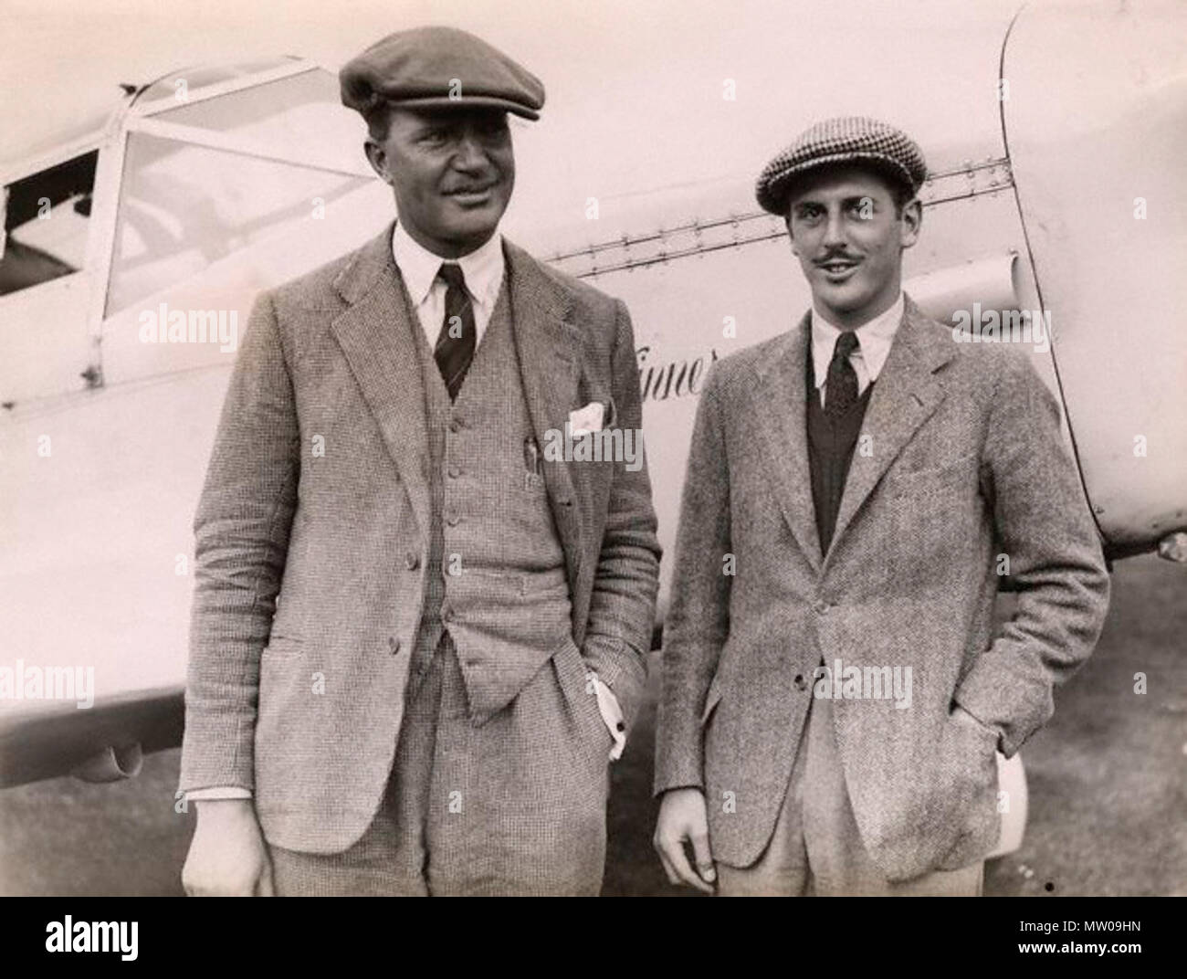 . English: C.W.A. Scott and Giles Guthrie, standing in front of the Percival Vega Gull G-AEKE in which they won the Schlesinger Air Race. September 1936. punlished by Planet News in 1936 unknown author 107 C.W.A. Scott and Guthrie vega gull Stock Photo