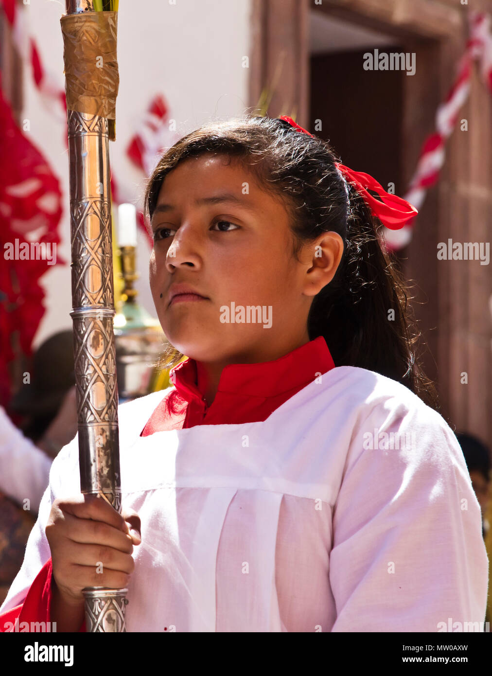 Young Catholic girls carry candles in the PALM SUNDAY PROCESSION from Parque Juarez to the Jardin - SAN MIGUEL DE ALLENDE, MEXICO Stock Photo