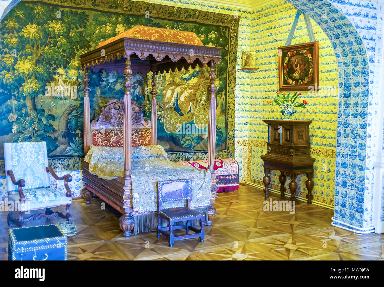 SAINT PETERSBURG, RUSSIA - APRIL 26, 2015: The bedroom of Menshikov Palace richly decorated with Delft's tiles, embroidered tapestry and expensive woo Stock Photo