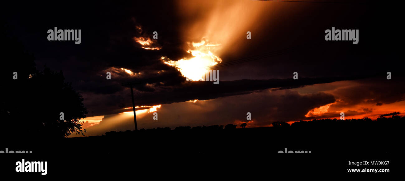 the sun peaking through the clouds after a storm Stock Photo