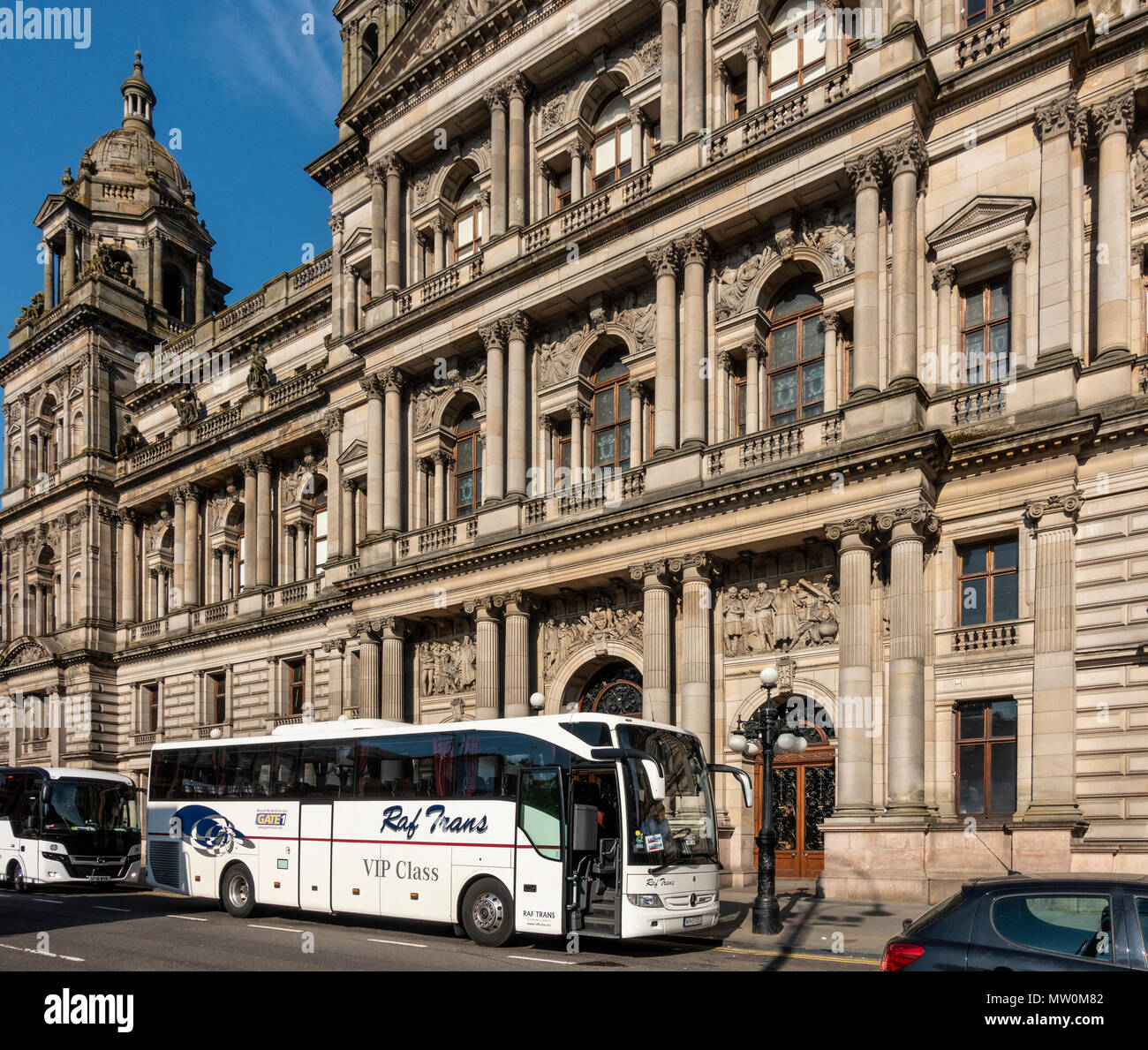 A Raf Trans luxury coach outside Glasgow City Chambers, the Town Hall in George Square in the city centre. Scotland, UK. Stock Photo