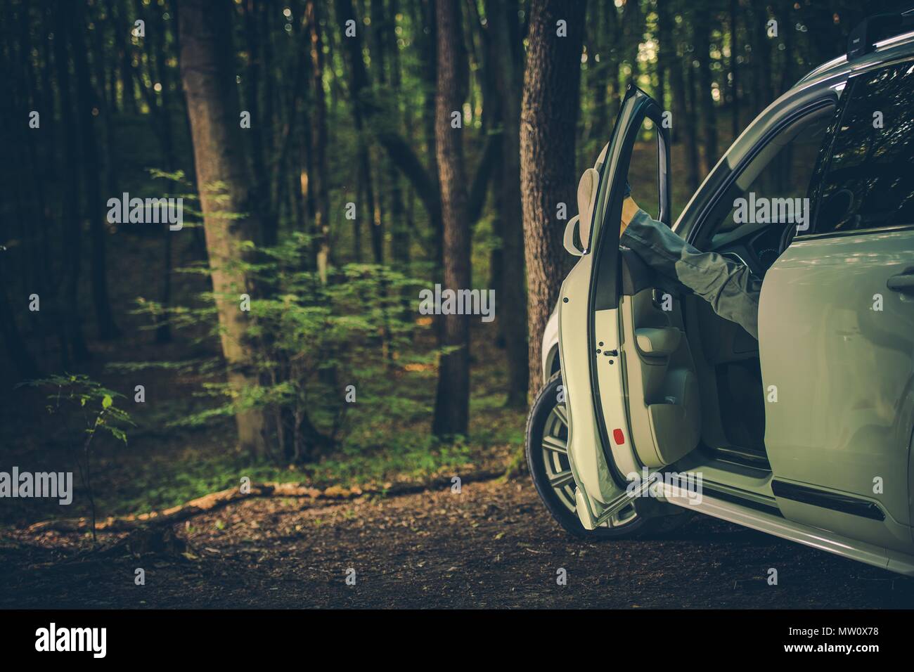 Businessman Relaxing in the Park Keeping Legs Out of the Car Window