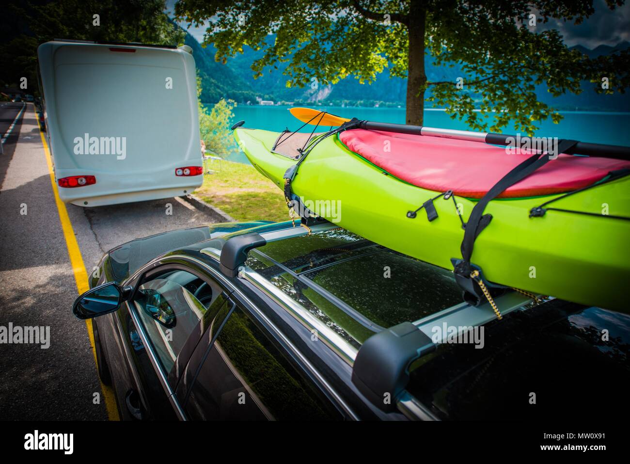 Summer Time Kayak Transportation on the Car Roof Rack. Vacation Trip with the Kayak. Stock Photo